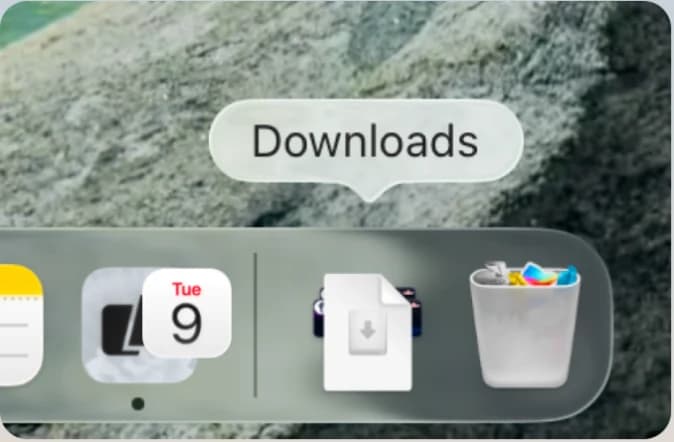 The macOS Dock with the Downloads folder open, showing the Nuan disk image.